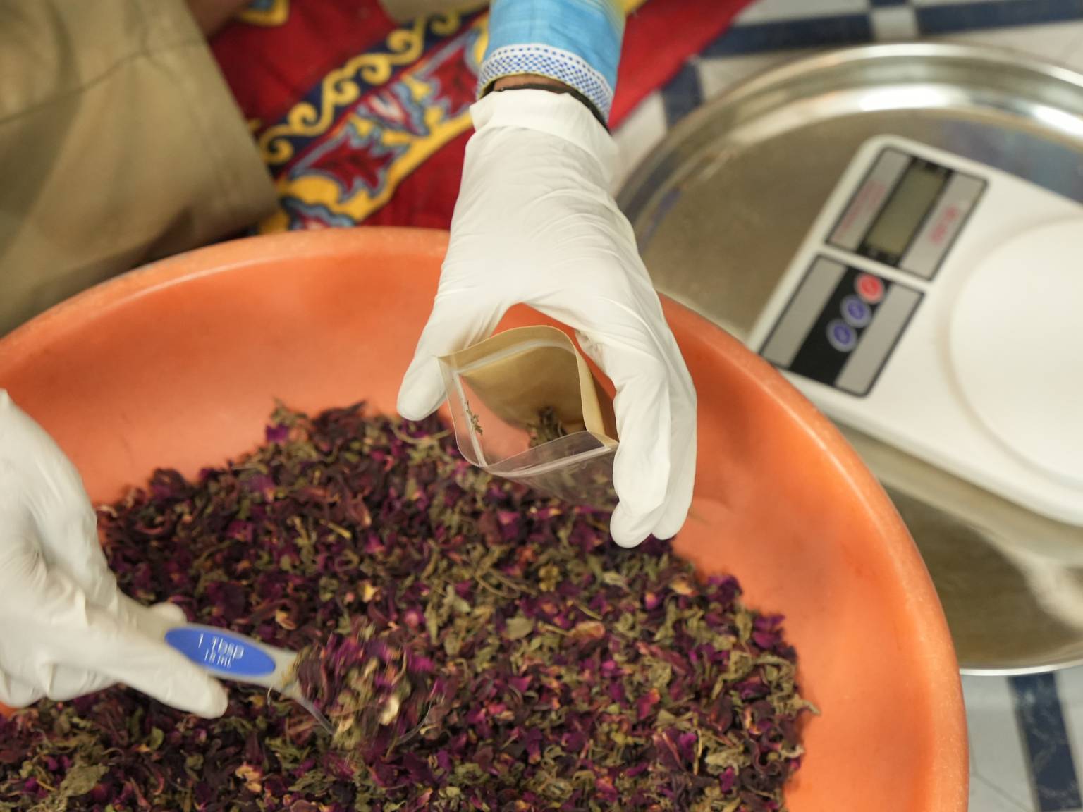 Hand packing a Calm Tea pouch at Calm Studio, Dehradun